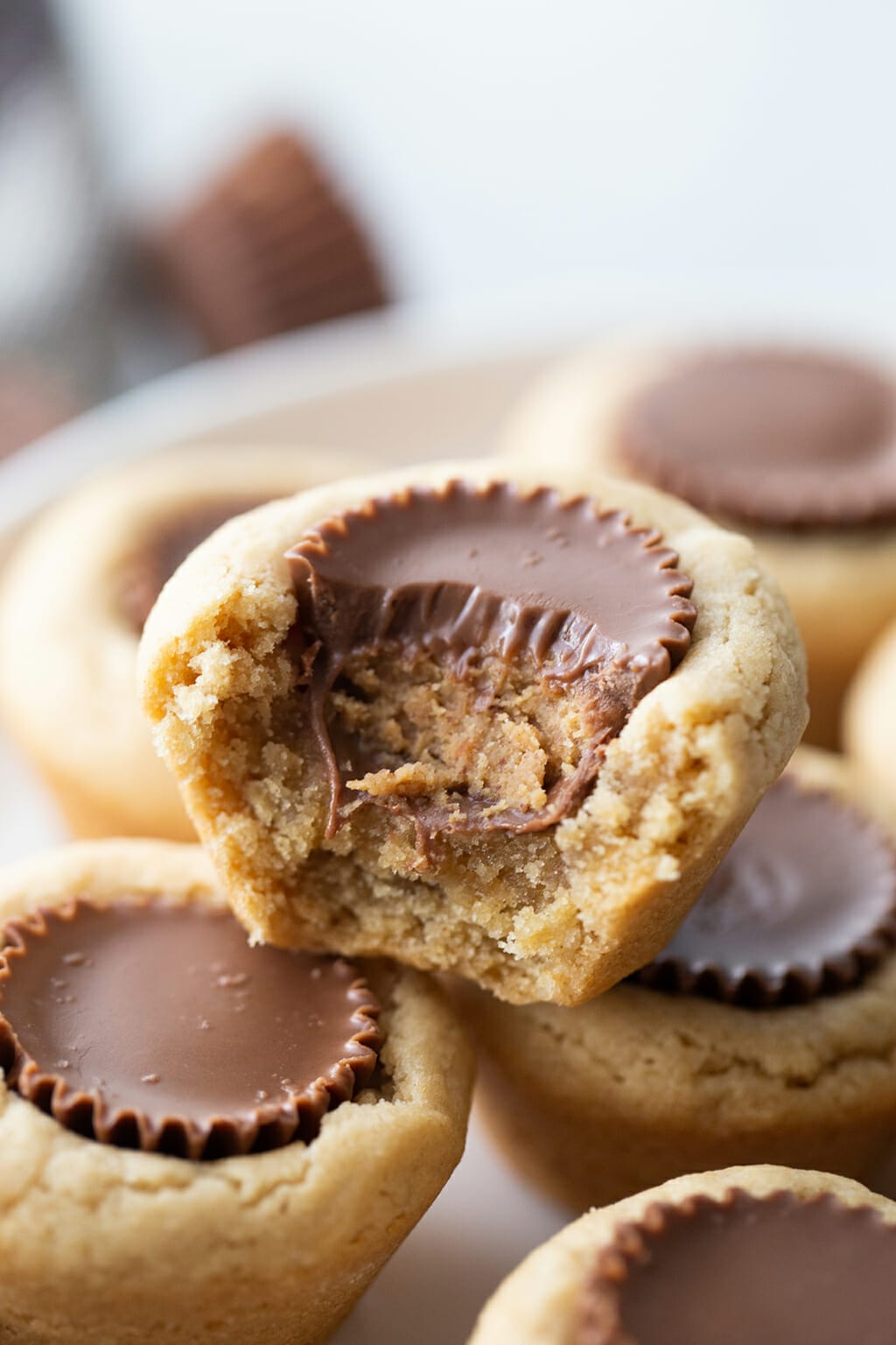 Peanut Butter Cup Cookies on a white plate, one has a bite out of it