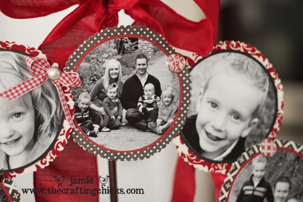 Black and white photos with embellishments on a red ribbon wrapped wreath to display.