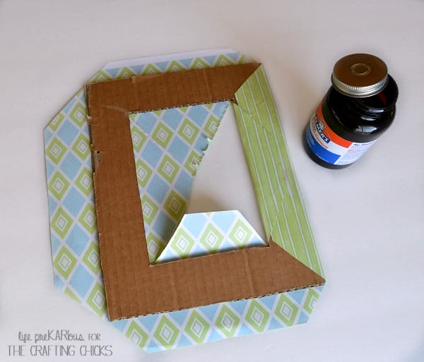 Use scrapbook paper and cardboard to make a cute photo mat