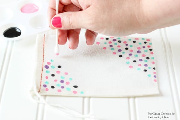 Add a painted confetti look to a muslin bag using paint and Q-tips