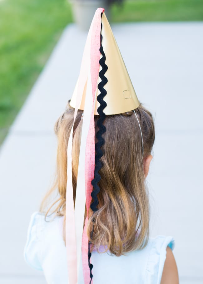DIY princess pointed hat on a little girl.