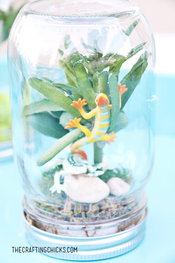 Mason Jar that has plastic lizard in it to make a Rainforest in a Jar for kids