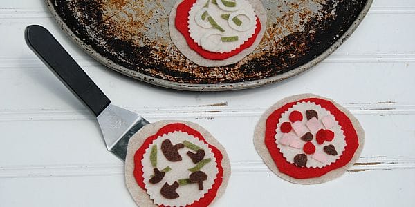 Gather the kids around the kitchen table to craft adorable mini Felt Pizzas! Let them add sauce, cheese and their favorite toppings - no oven required!