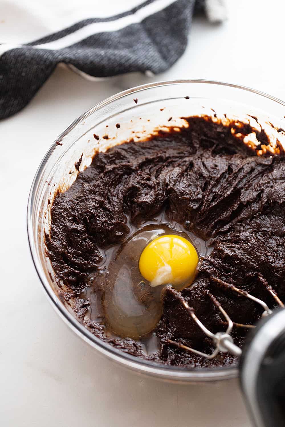Adding an egg to the Decadent Double Chocolate Crinkle Cookie batter