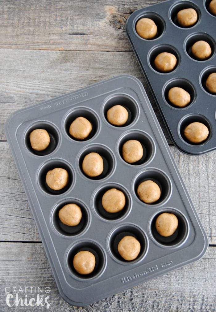 Roll pre-made peanut butter cookie dough into 24 balls - such an easy start to these Fluffernutter Cookie Cups!