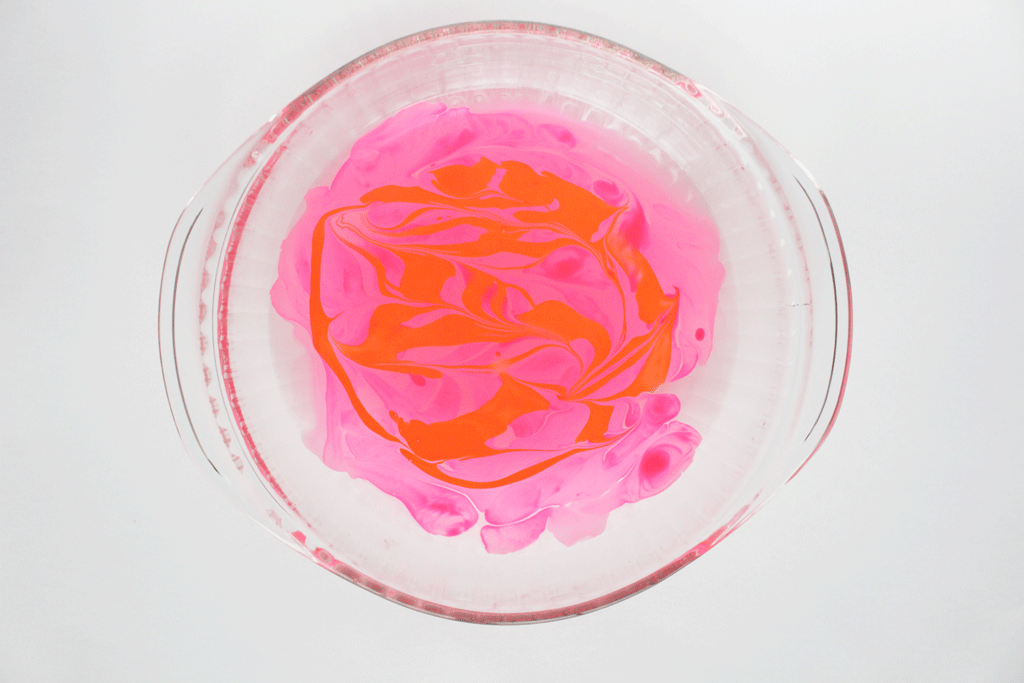 Nail Polish drops in water in a glass bowel.