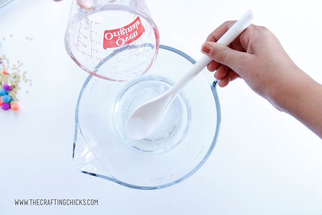 Add water and baking soda mixture into clear glue to make galaxy slime.