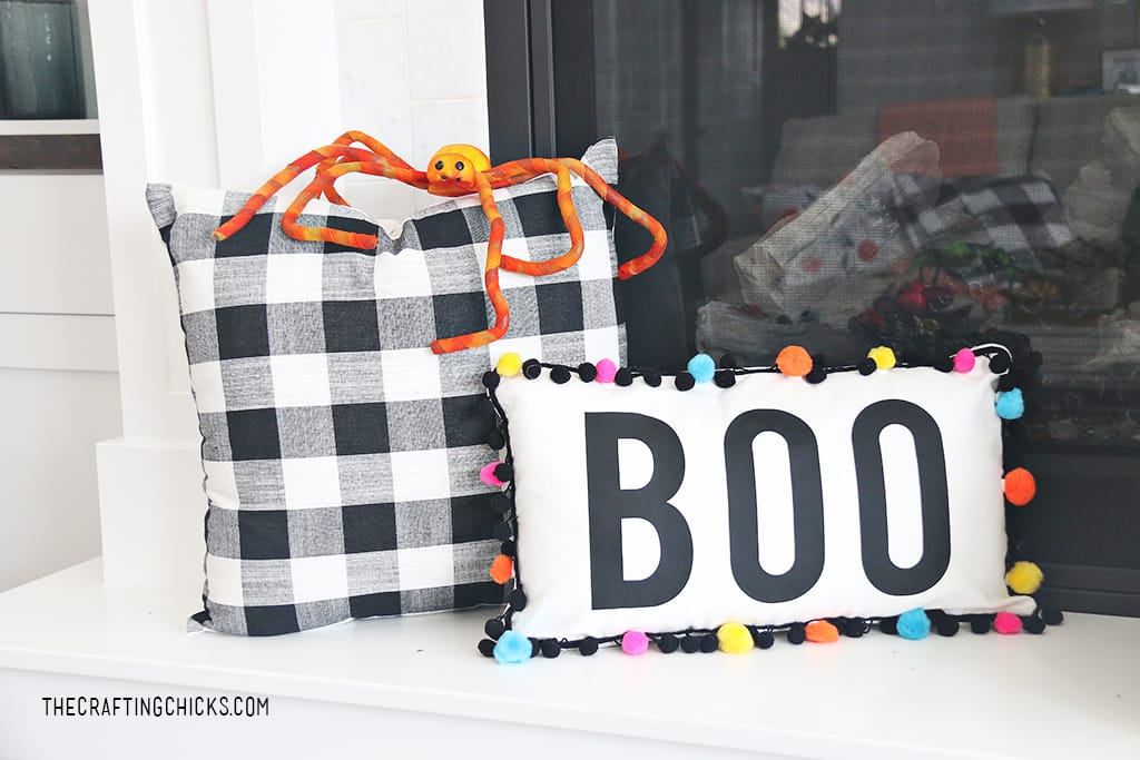 Boo Pillow with bright colorful pom poms around as trim for Halloween decor