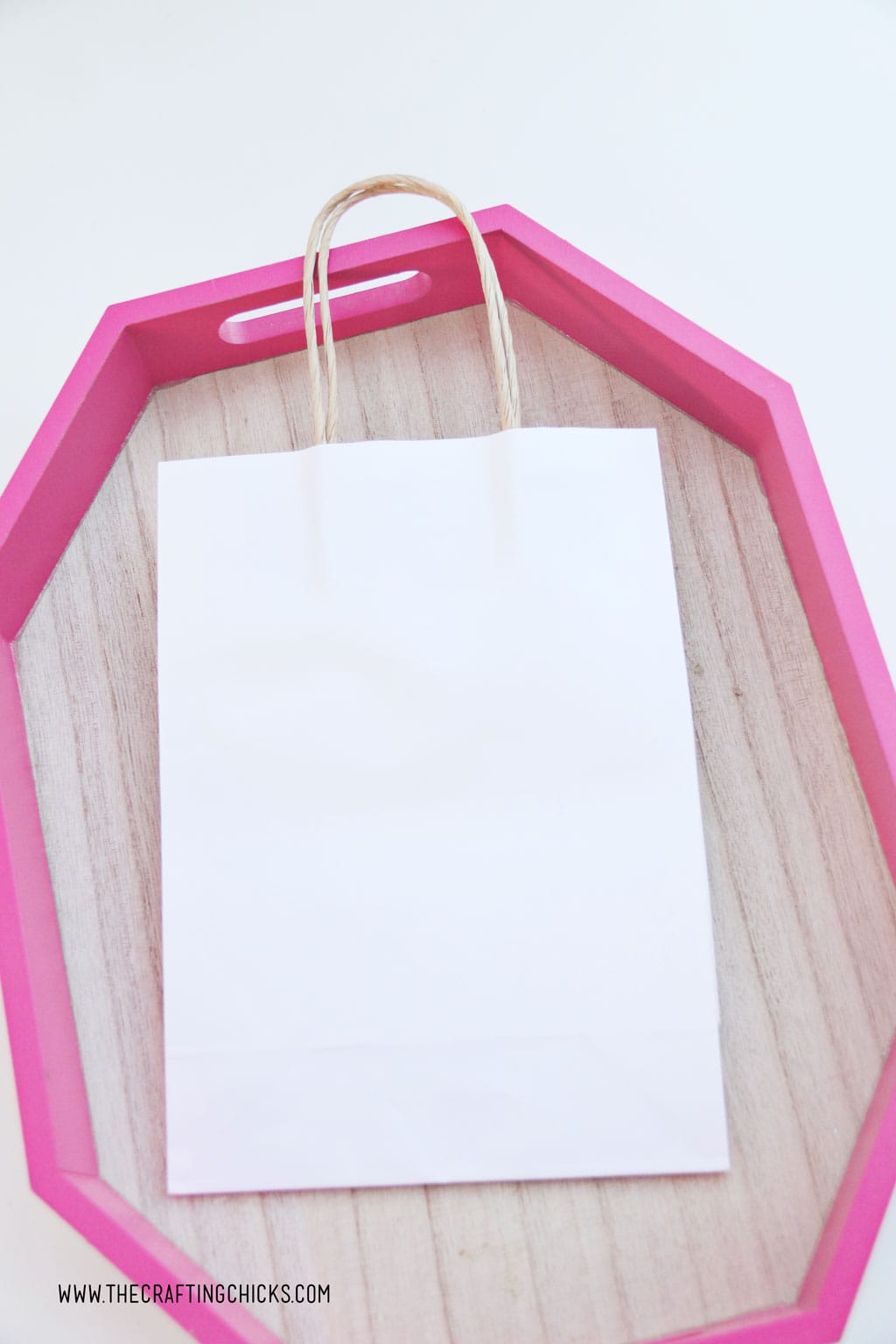 White gift bag on pink tray to make Hello Kitty DIY Gift Bags