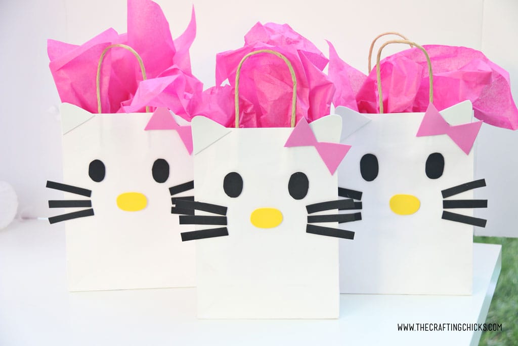 Bright pink tissue paper added to white gift bag to make a DIY Hello Kitty Gift Bags