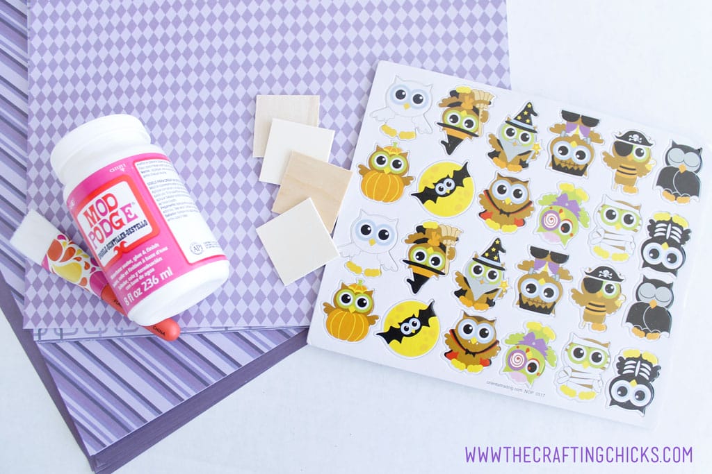 Purple scrapbook paper, wooden squares, sparkle Mod Podge, Halloween Owl stickers are what you need to make Halloween Owl Memory Game
