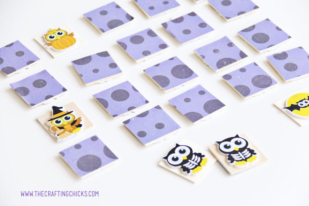 Halloween Owl Memory game with wooden pieces covered in purple paper and puffy owl stickers on the back.