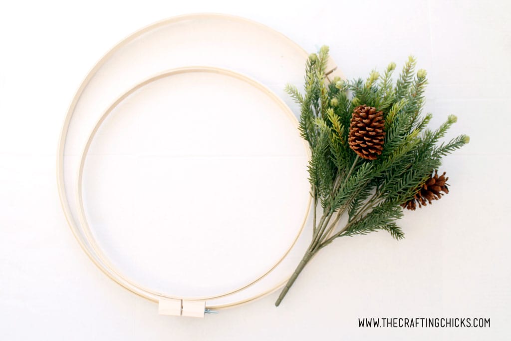 2 large embroidery hoops and a bunch of faux pine.