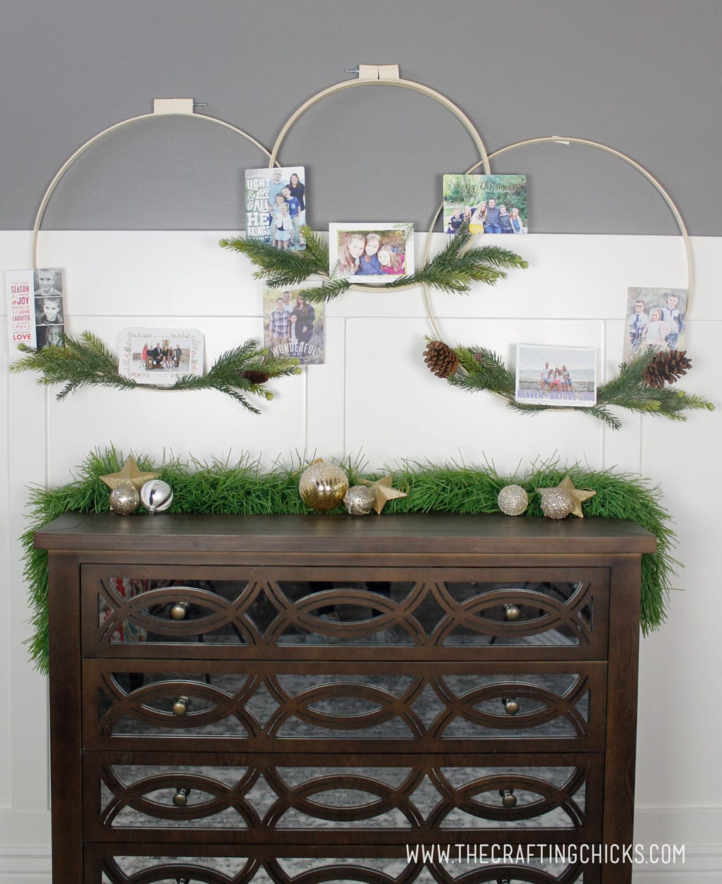 Winter hoop wreaths decorated with Christmas and holiday cards with pine sprigs. 