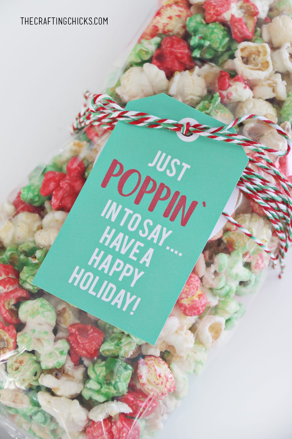 Just Poppin' In Christmas Popcorn Tag added to red, green, and white popcorn for a holiday gift idea.
