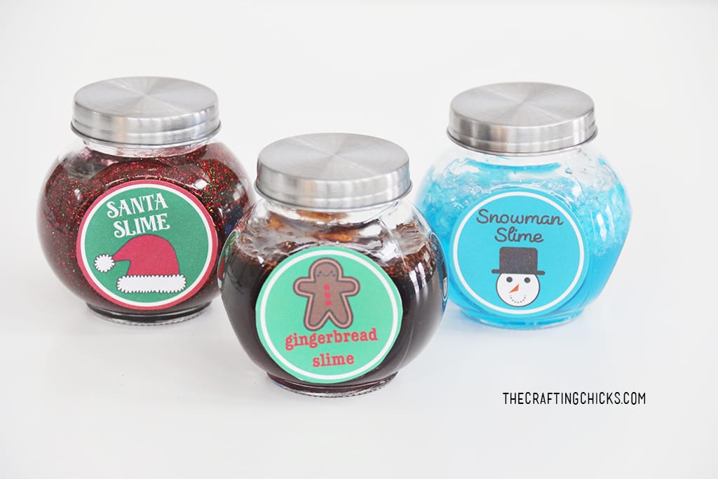 Santa Slime, Gingerbread slime, and Snowman slime in jars with lids on a white background
