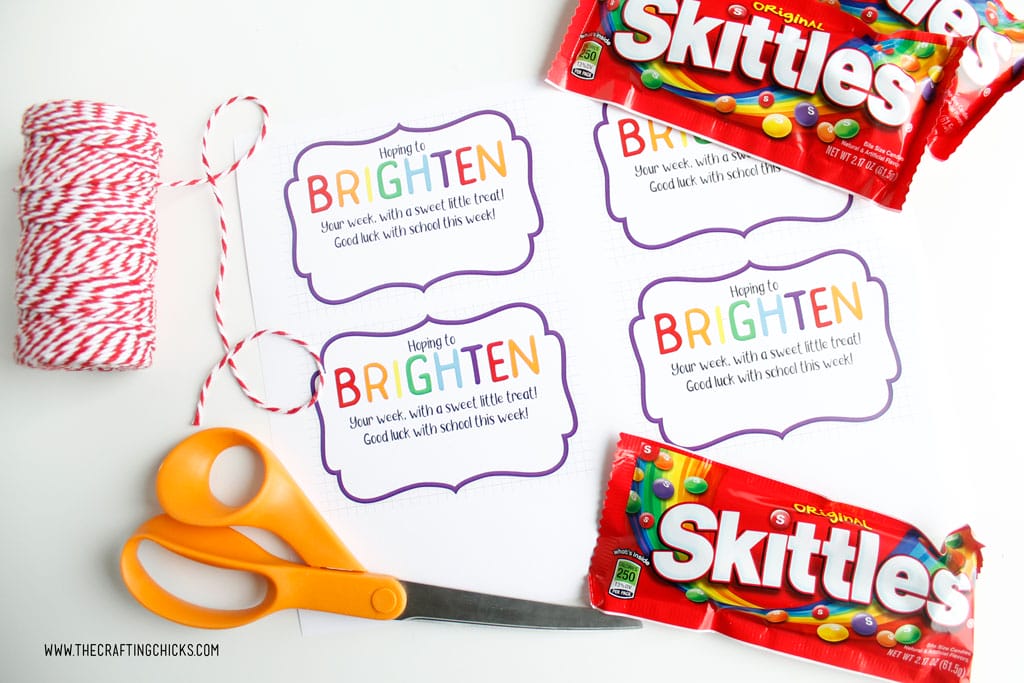 Brighten your day printable gift tags printed out with bakers twine, scissors, and skittles