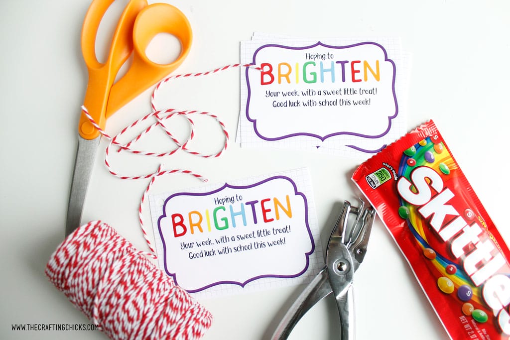 Scissors, Brighten your day printable gift tag, baker's twine, hole punch and Skittles to make Brighten Your Day gift
