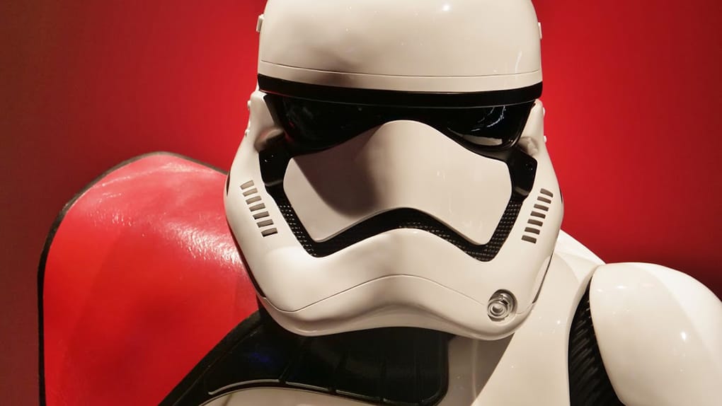 Star Wars Storm Trooper in front of red wall at Disneyland