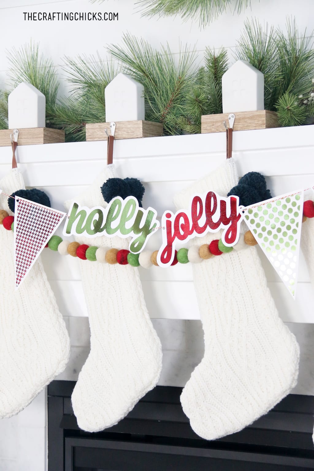 White Stockings on a mantle with adorable foiled Holly Jolly banner