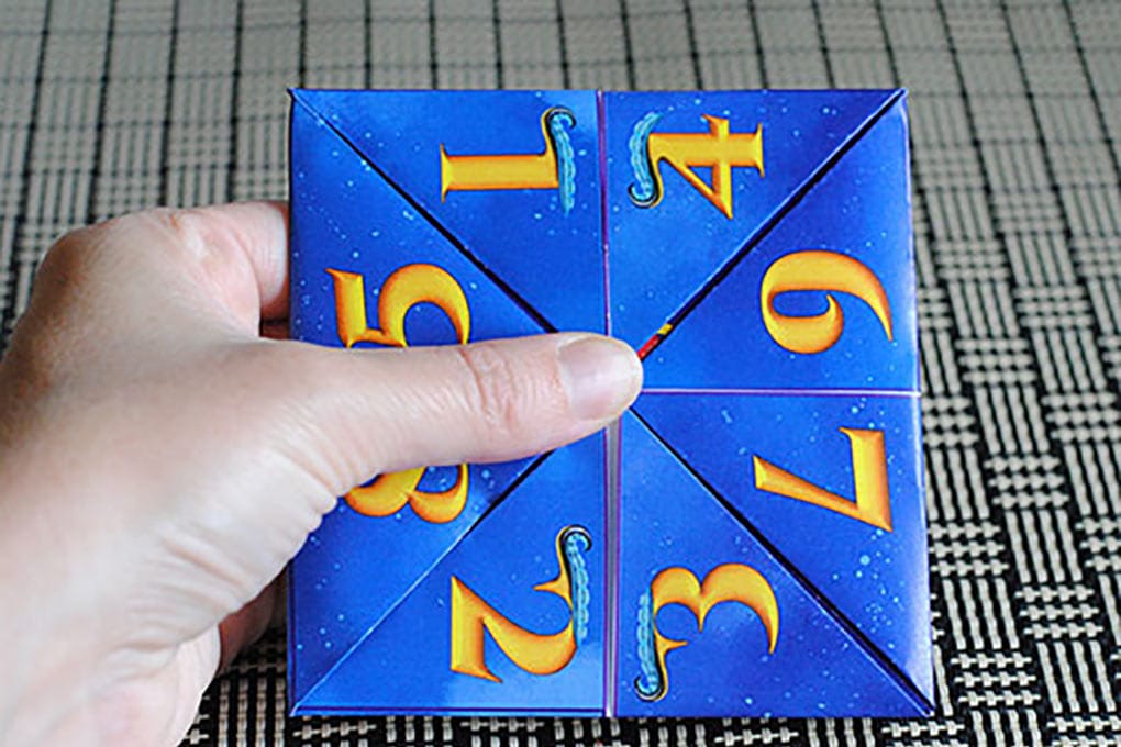 Descendants fortune teller printable being folded into a fortune teller.