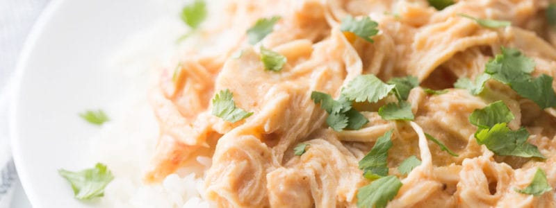 Crockpot Fiesta Ranch chicken served over white rice with cilantro sprinkled over top.