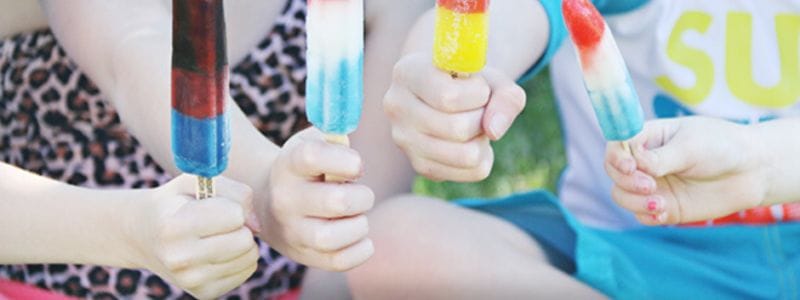 Kids holding popsicles