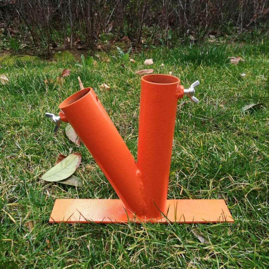 Bright orange metal pipes that are used to hold and umbrella. Lawn Umbrella stand.