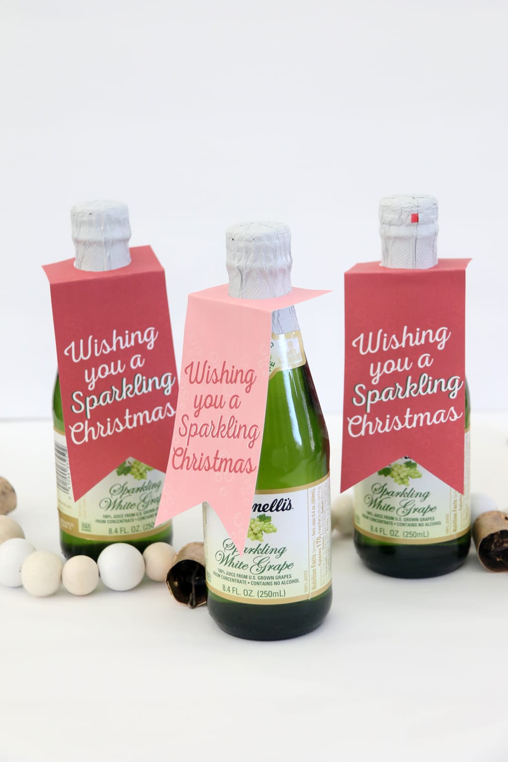 Wishing you a Sparkling Christmas printable tag on a bottle of sparkling cider.
