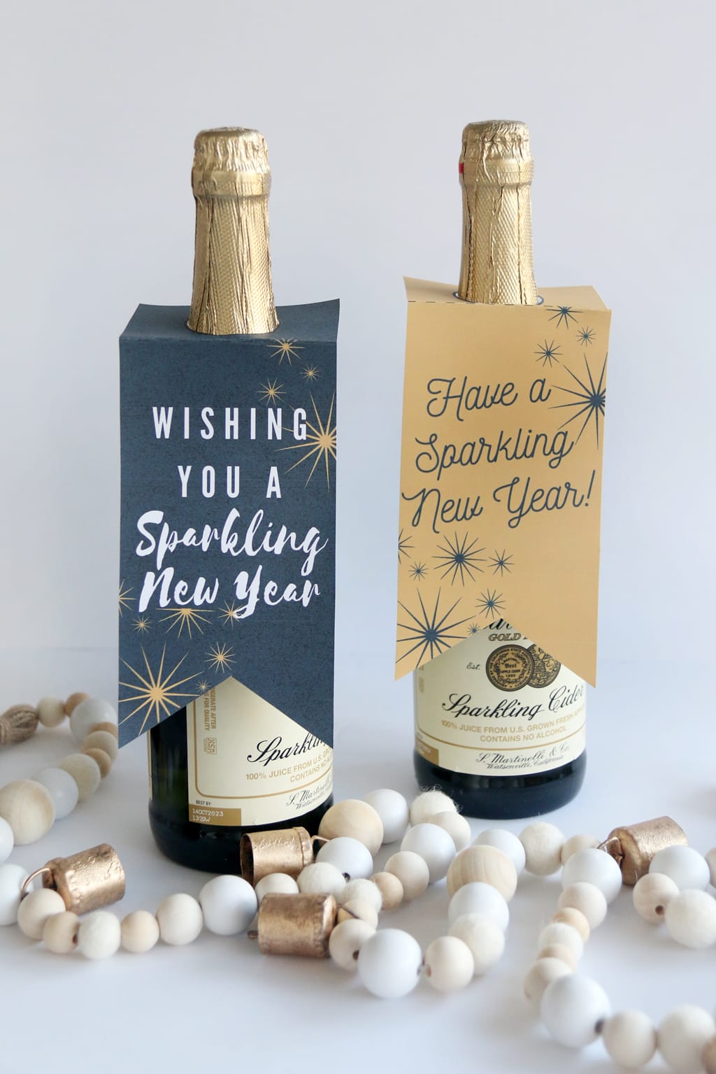 New Year Sparkling Cider Gift Tags on bottles of sparkling cider 