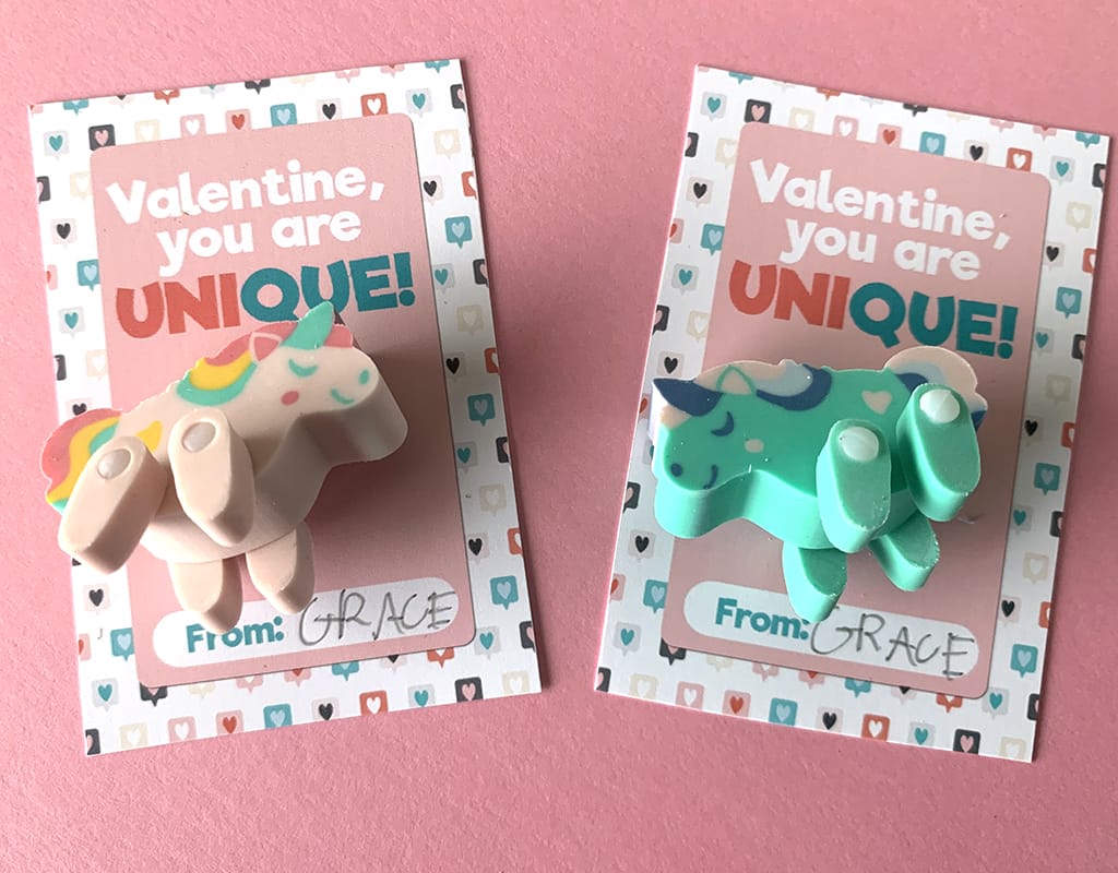Pink and green unicorn erasers on Free Unicorn Printable Valentines on pink background