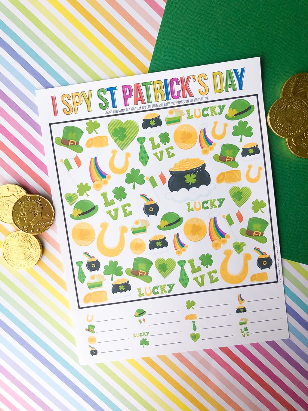 St. Patrick's Day I Spy Printable Game on a rainbow colored, and a green paper background with gold coins around.